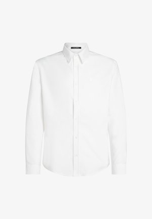 Valge nööpidega särk, mis on valmistatud puuvillast ja millel on sile tekstuur. Särgil on klassikaline krae, pikad varrukad ja väikene logo rinnal.