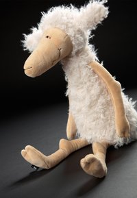 Plush toy sheep with a textured white fluffy body, beige limbs, and a simple stitched face. Has large floppy ears and a curved snout.