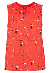 Haut sans manches rouge avec un décolleté à nouer et un motif de petites figures et tourbillons en noir, blanc et bleu clair sur un tissu texturé.