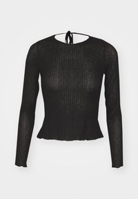 Schwarzes Langarmoberteil aus geripptem Material mit einem Peplum-Saum und einer Schleife am Rücken. Weiches Material mit leichtem Glanz, figurbetonte Silhouette.