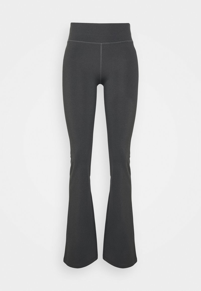 Mörkgrå höga leggings med en hög midja, tillverkade av ett elastiskt, jämnt tyg. Har ton-i-ton sömmar genom hela plagget.