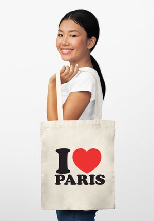 Torba na ramię z płótna w kolorze ecru z napisem "I ♥ Paris" wydrukowanym grubymi czarnymi i czerwonymi literami. Regulowane ramiączka i prosty design.