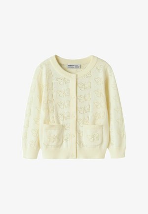 Kremowy sweter na guziki z nadrukiem motyli, z przodu guziki, ściągacze przy mankietach i u dołu oraz dwie przednie kieszenie z motywem motyli.