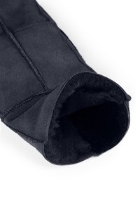 Black suede mitten with plush lining, featuring a folded cuff and visible stitching, displaying a soft texture and modern design.