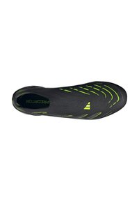 Black soccer shoe with a sleek design, featuring green accents and textured overlays for grip, showcasing a streamlined, athletic silhouette.