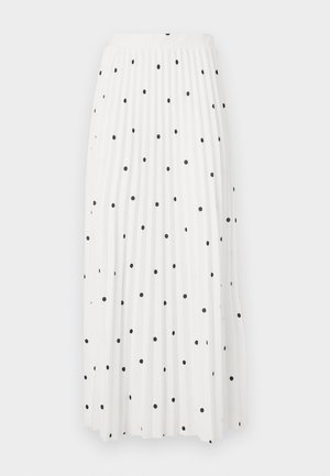 Bela maksi krila z črnimi pikami po vsej površini, ki ima gladek pas in tekočo tkanino za enostavno gibanje.