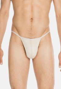 Beige Tangas aus einem glatten, elastischen Stoff. Dünne elastische Träger an den Seiten. Nähte sind entlang der Vorderpartie sichtbar.