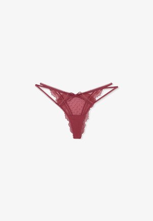 Maroon lace thong with sheer dotted mesh fabric, scalloped edges, double thin side straps, and a small bow at the front center.