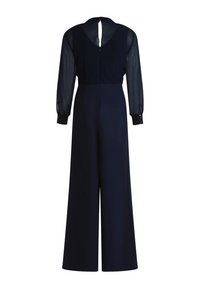 Marinblå overall med långa genomskinliga ärmar, nyckelhål i ryggen och vida ben. Slätt material med knappdetaljer vid mudden.