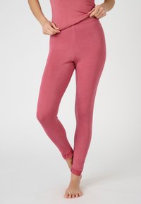 Leggings rosa realizzati in un tessuto morbido e con un design aderente, caratterizzati da un bordo in pizzo alle caviglie e una vita elastica.