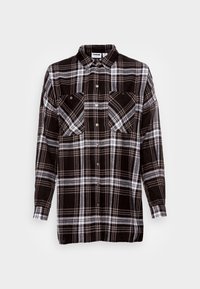 Camicia in flanella a quadri bianco e nero con maniche lunghe, due tasche sul petto e chiusura con bottoni. Tessuto morbido con una vestibilità comoda.