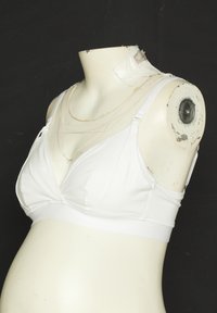 White maternity bralette made of soft fabric, featuring a smooth texture, V-neck design, adjustable straps, and elastic band for support.