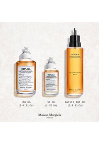 Kolme Maison Margiela Replica By the Fireplace -tuoksupulloa: 100 ml, 30 ml suihke ja 100 ml täyttöpullo valkoisella taustalla.