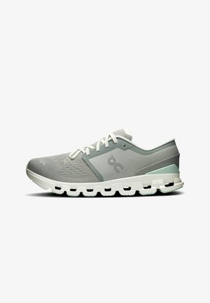 Light gray and white running shoe with mesh upper, cushioned sole with hollow segments, and lace-up closure, viewed from the side.
