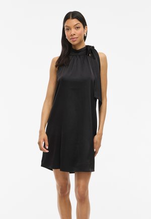 Black sleeveless dress in smooth fabric with a gathered neckline and side bow detail, featuring a relaxed fit and above-the-knee length.