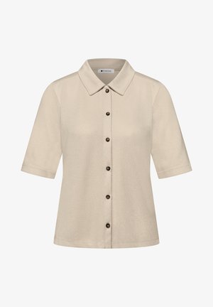 Camicia beige a maniche corte con colletto appuntito e bottoni scuri, realizzata in tessuto morbido e strutturato.
