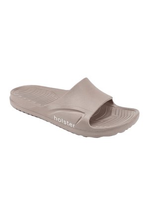 Hellbraune Slip-On-Sandale mit strukturiertem Fußbett und „holster“-Logo an der Seite, für den Freizeitgebrauch entworfen.