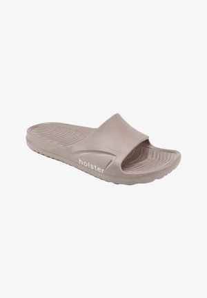 Lichtbruine slip-on teenslipper met gestructureerd voetbed en "holster" logo aan de zijkant, ontworpen voor casual gebruik.