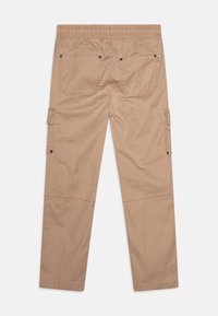 Beige cargo pants with an elastic waistband, two back pockets, and side pockets. Fabric has a smooth texture and a straight leg design.