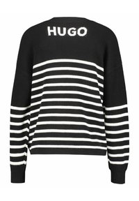 Pull en maille à rayures noires et blanches avec le logo HUGO dans le dos. Présente une coupe décontractée et des poignets côtelés. Les rayures varient en largeur.