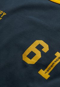 Navy blue cotton fabric with a smooth texture featuring bold yellow numbers '61' and '69' printed prominently.