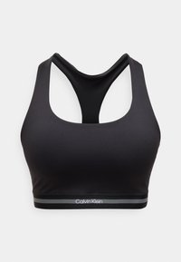 Μαύρο αθλητικό μπουστάκι χωρίς ραφές με σχέδιο racerback και ελαστική ταινία με το λογότυπο Calvin Klein σε λευκές και γκρι ρίγες.
