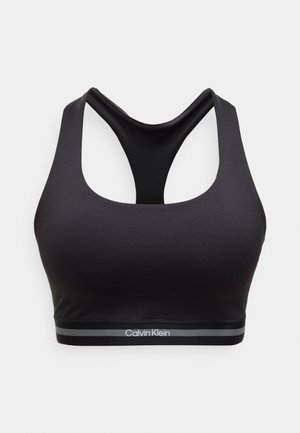 Musta saumaton urheiluliivit, joissa on racerback-malli ja joustava nauha, jossa on Calvin Kleinin logo valkoisissa ja harmaissa raidoissa.