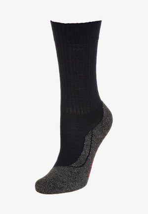 Chaussette de crew noire avec texture côtelée, talon et orteil renforcés gris, arborant de subtils accents métalliques à la base.