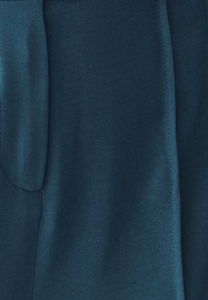 Sügav teali värvi kangas, millel on sile tekstuur ja diagonaalsed kudumismustrid. Servad on korralikult viimistletud, rõhutades disaini lihtsust.