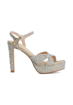 Gold high-heeled sandal with ankle strap, platform sole, and covered in sparkling rhinestones for decorative detail.