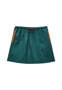 Jupe légère et verte avec une taille élastique. Dotée de poches zippées oranges et d'un cordon décoratif en rouge et noir. Design plat.