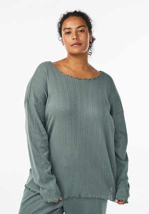 Olive green long-sleeve top with a wide scalloped neckline, ribbed texture, and frayed hem. Fabric appears soft and slightly stretchy.