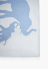 Light blue throw blanket featuring a subtle elephant and monkey silhouette pattern. Soft texture with fringed edges.
