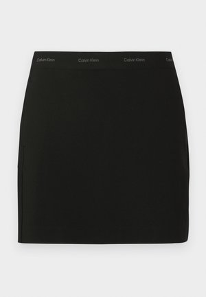 Black mini skirt made of smooth fabric. Features a branded elastic waistband and side pockets. Simple, sleek design with no additional patterns.
