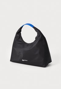 Black nylon bag with a rounded design, blue handle, and a zip closure. Features white logo at the front. Smooth texture.