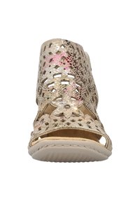 Beige cutout sandal featuring a textured metallic surface, floral accents, and an open toe design with a cushioned sole.