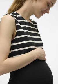 Black and white striped maternity top with a round neckline, short sleeves, and soft fabric, hugging a visible pregnant belly.