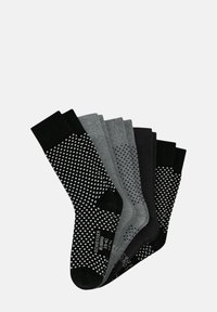 Sei paia di calze in colori nero, grigio e con design a fantasia. Calze nere testurizzate con pois bianchi, grigie lisce e nere. Materiale in misto cotone.