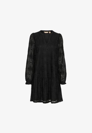 Mustre loorus pikkade varrukatega must pitskleit, V-kaelus ja kihiline seelik. Lilleline muster kogu kleidi ulatuses, koos volditud mansettide ja vabalt langeva lõikega.