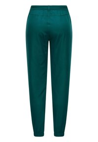 Teal joggers med elastisk midja och muddar, slät tyg, avsmalnande bendesign och inga synliga fickor eller hardware-detaljer.