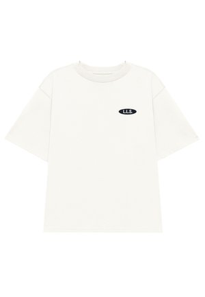 Kurzärmliges, Rundhals-T-Shirt aus leichtem beigem Stoff. Mit einem kleinen schwarzen ovalen Patch mit dem "L.L.S." Logo auf der Brust.