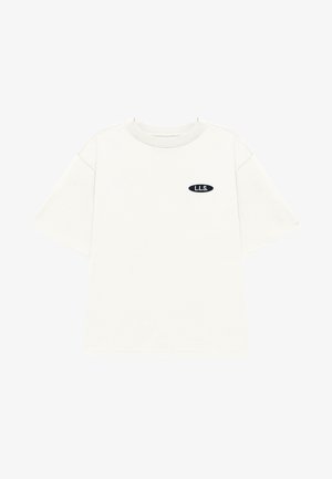 Short-sleeve, crewneck t-shirt in light beige fabric. Features a small black oval patch with "L.L.S." logo on the chest.