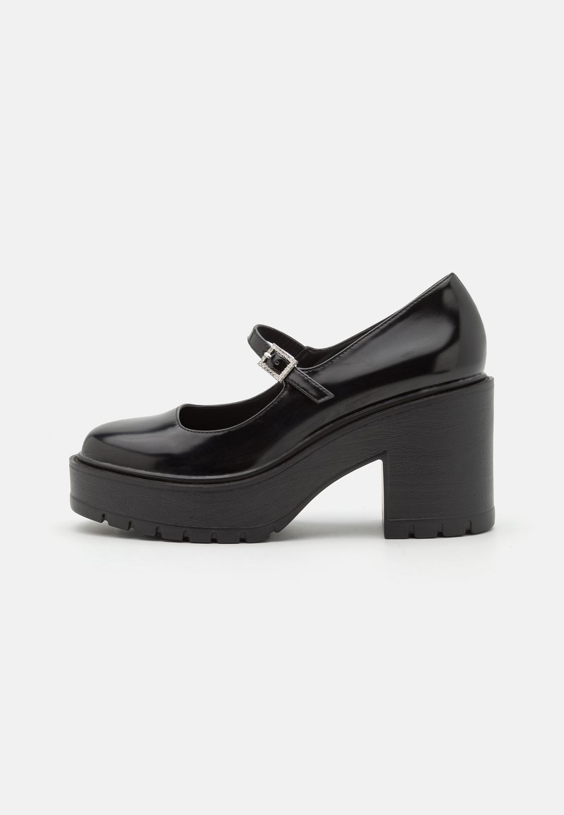 Chaussure Mary Jane noire à plateforme avec une finition brillante, bout rond, bride de cheville avec boucle, et talon bloc texturé et épais.