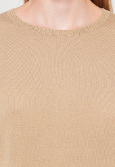 Beige knit top with a round neckline and fine ribbed texture, featuring a smooth and slightly fitted design.