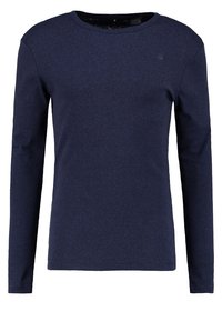 Námořnická modrá mikina s dlouhým rukávem a kulatým výstřihem s malým, nenápadným logem na horním hrudníku.