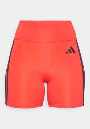 Bright red athletic shorts with a high waist, featuring black side stripes and an Adidas logo. Made of stretchy fabric for comfort.