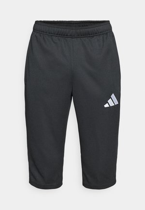 Schwarze Sportshorts mit elastischem Bund, knielanger Länge und einem weißen Adidas-Logo mit drei schrägen Streifen auf der linken Seite.