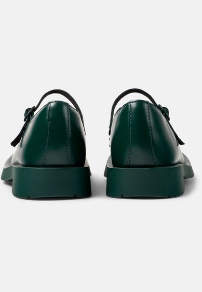 Dark green leather shoes with a smooth finish, rounded toe, and flat rubber sole. Features a decorative bow on the lace area.