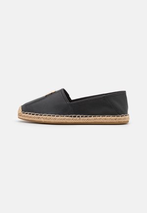 Black leather espadrille with a jute rope sole, featuring a closed toe and a decorative accent on the upper side.