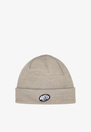 Beige knit beanie with a folded cuff, featuring an oval patch with a logo and stars. Soft texture, close-knit fabric with seamless design.